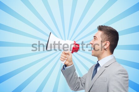 happy businessman in suit speaking to megaphone Stock photo © dolgachov