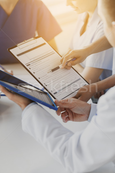 Stock photo: close up of doctors with clipboard at hospital