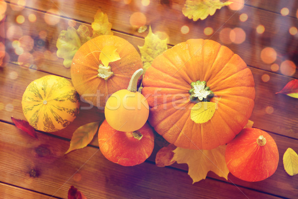 close up of pumpkins on wooden table at home Stock photo © dolgachov