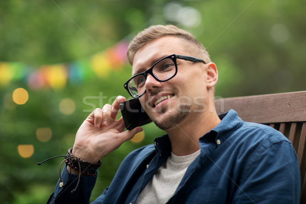 man calling on smartphone at summer garden party Stock photo © dolgachov