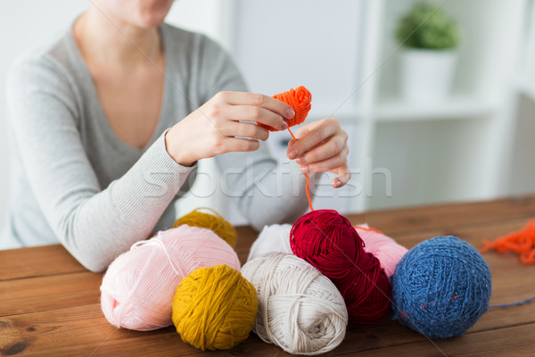 woman pulling yarn up into ball Stock photo © dolgachov