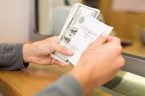 customer with money and receipt at bank counter Stock photo © dolgachov