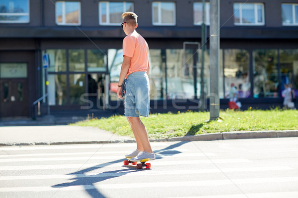 teenage boy on skateboard crossing city crosswalk Stock photo © dolgachov