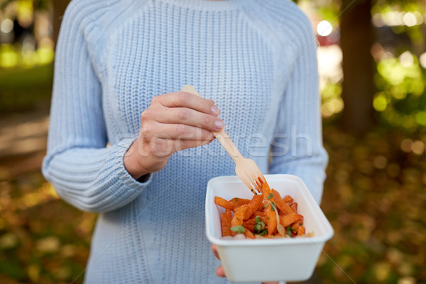 Stock photo: close up of hand holding plate with sweet potato