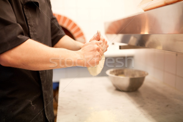 chef hands preparing dough on table at kitchen Stock photo © dolgachov