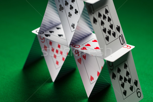 close up of house of playing cards on green cloth Stock photo © dolgachov
