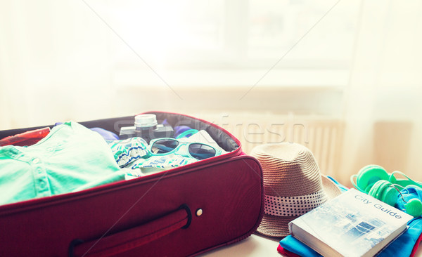 close up of travel bag with clothes and stuff Stock photo © dolgachov