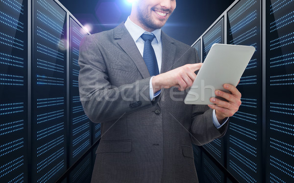 businessman with tablet pc over server room Stock photo © dolgachov