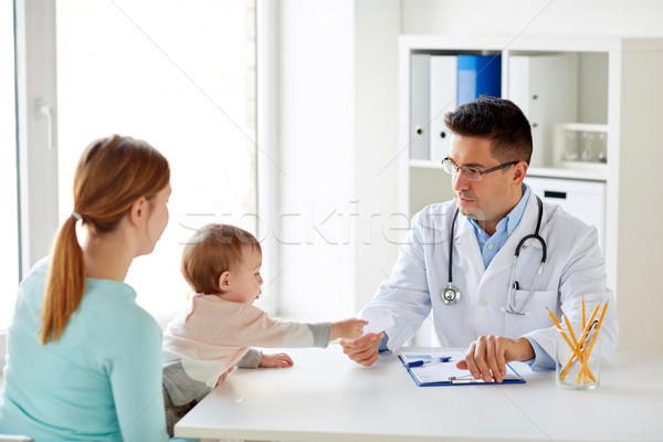 woman with baby and doctor at clinic Stock photo © dolgachov