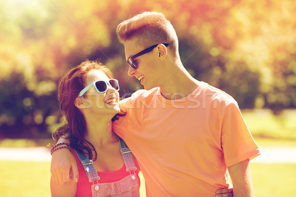 happy teenage couple looking at each other in park Stock photo © dolgachov