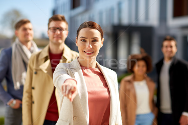 happy smiling woman pointing finger at you  Stock photo © dolgachov