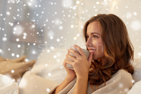 happy woman with cup of coffee in bed at home Stock photo © dolgachov