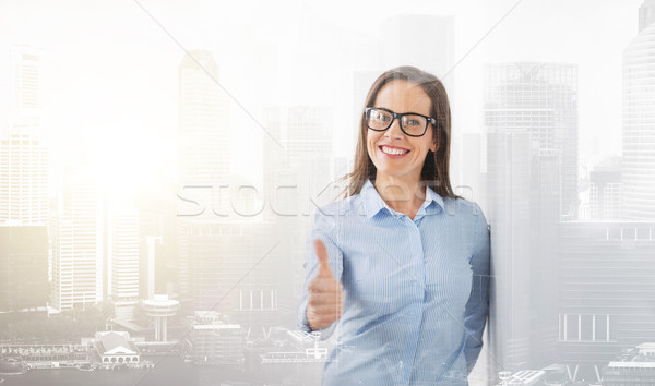 happy smiling woman in glasses showing thumbs up Stock photo © dolgachov