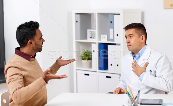 doctor and displeased male patient argue at clinic Stock photo © dolgachov
