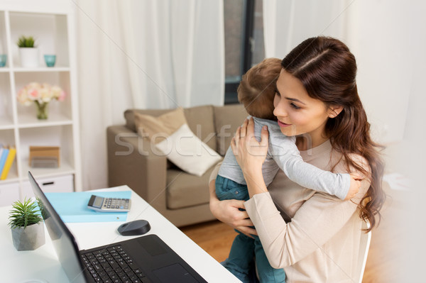 happy mother with baby and laptop working at home Stock photo © dolgachov