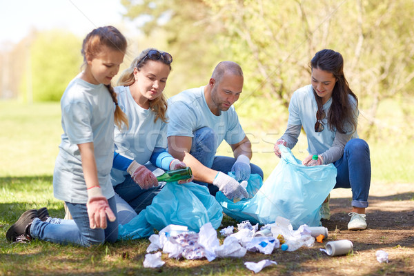 volunteers with garbage bags cleaning park area Stock photo © dolgachov