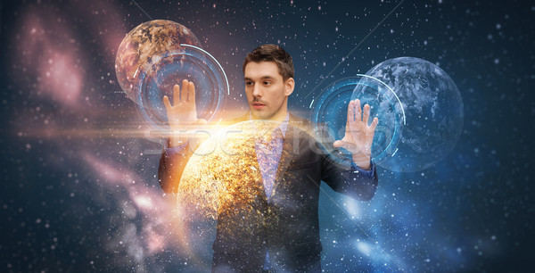 businessman with virtual planets and space Stock photo © dolgachov