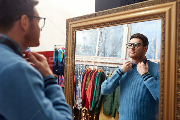 man looking at mirror at vintage clothing store Stock photo © dolgachov