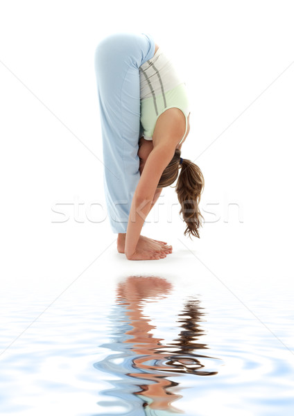uttanasana standing forward bend on white sand Stock photo © dolgachov