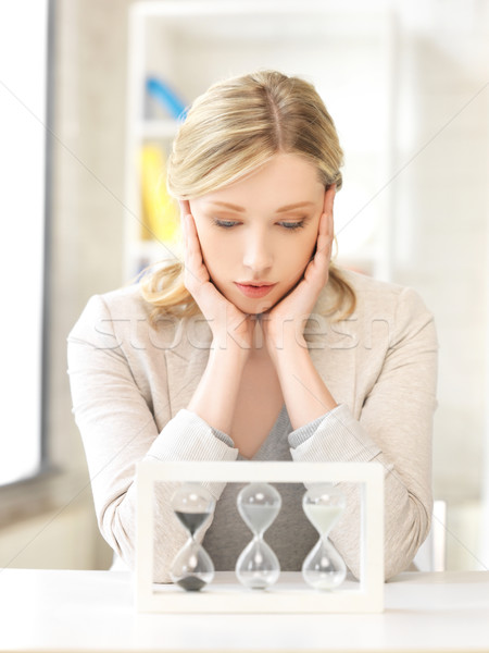 Stock photo: pensive businesswoman with sand glass