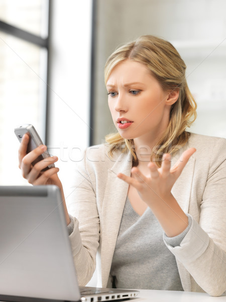 confused woman with cell phone Stock photo © dolgachov