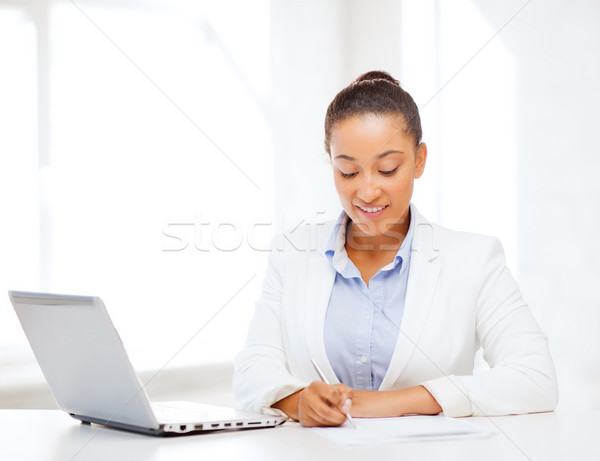 african businesswoman writing something Stock photo © dolgachov