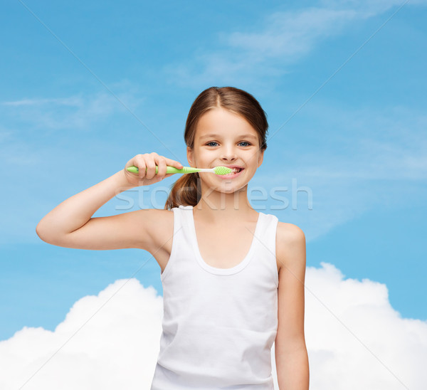 girl in blank white shirt brushing her teeth Stock photo © dolgachov