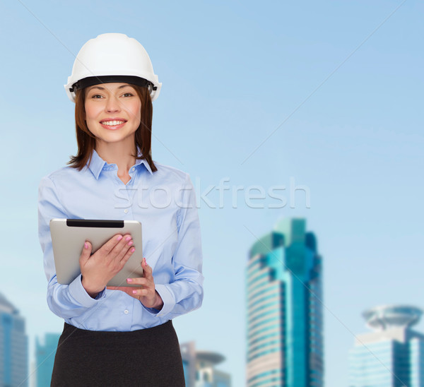 Jovem sorridente empresária branco capacete edifício Foto stock © dolgachov