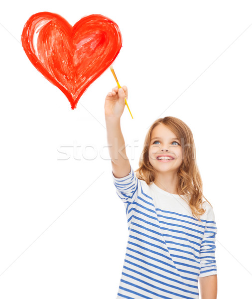 cute little girl drawing heart with brush Stock photo © dolgachov