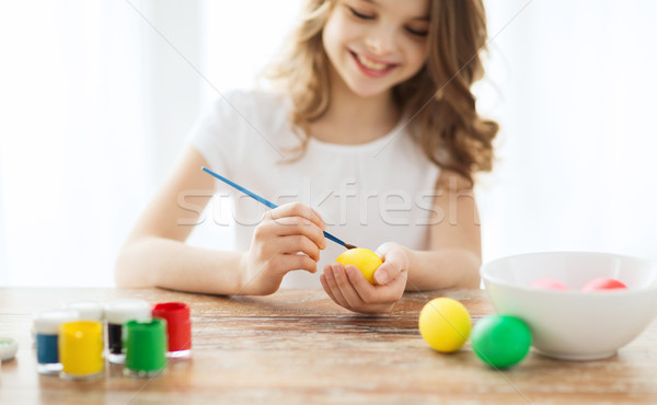close up of girl coloring eggs for easter Stock photo © dolgachov
