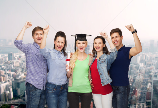 group of standing smiling students with diploma Stock photo © dolgachov