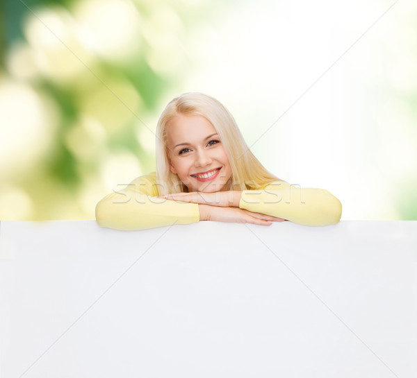 smiling woman in sweater with blank white board Stock photo © dolgachov