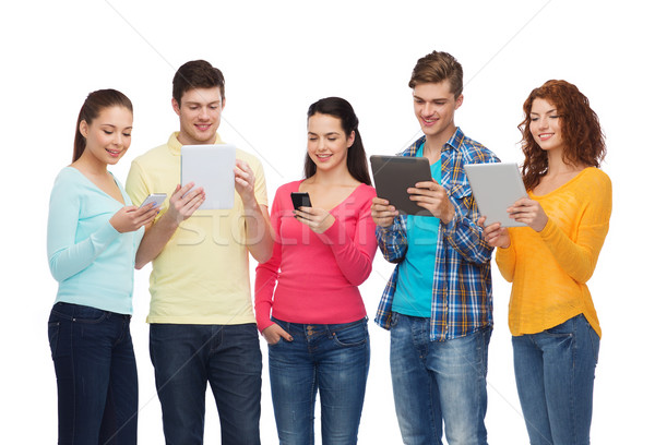 Stock photo: group of teenagers with smartphones and tablet pc