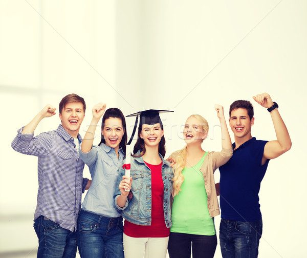 group of standing smiling students with diploma Stock photo © dolgachov