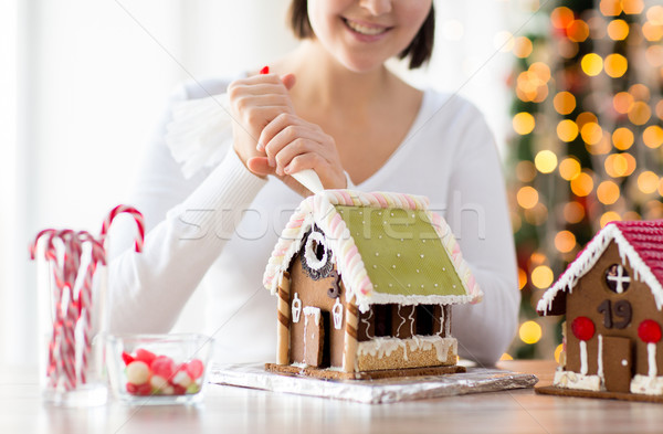 Stock photo: close up of woman making gingerbread houses