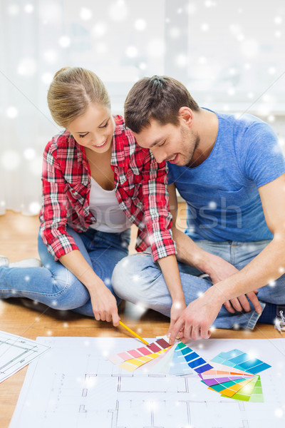 Stock photo: smiling couple selecting color from samples