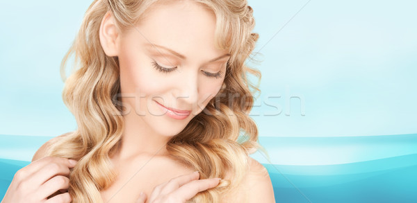 beautiful young woman face with long wavy hair Stock photo © dolgachov