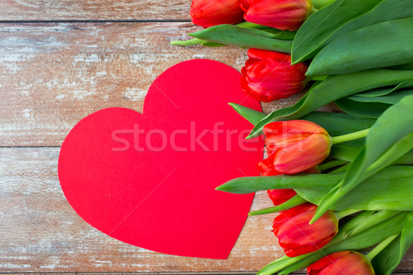 close up of red tulips and paper heart shape card Stock photo © dolgachov