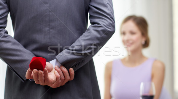 close up of man hiding red box behind from woman Stock photo © dolgachov