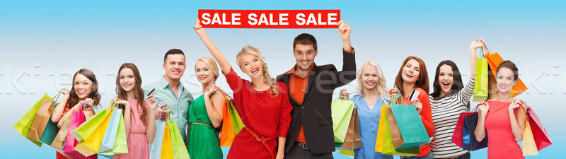 Boldog emberek piros vásár felirat bevásárlótáskák fogyasztói társadalom Stock fotó © dolgachov