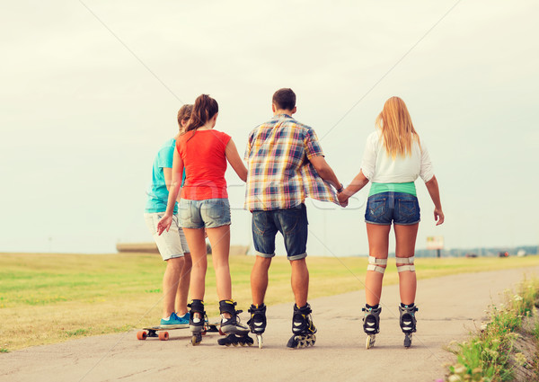 group of teenagers with roller-skates Stock photo © dolgachov