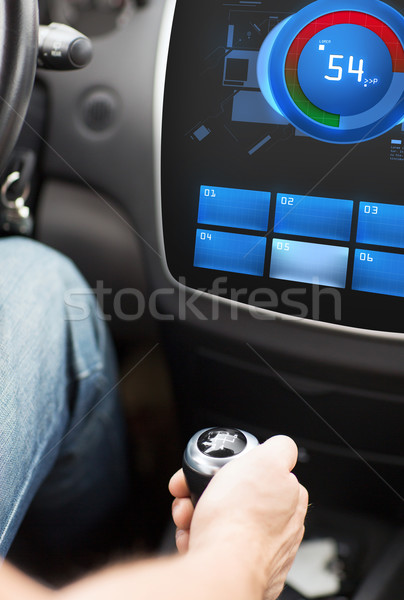 hand on car gearshift and screen with volume level Stock photo © dolgachov