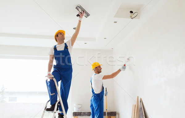 group of builders with tools indoors Stock photo © dolgachov