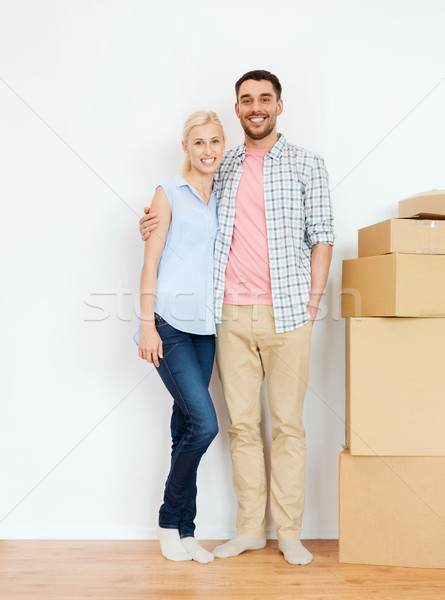 couple with cardboard boxes moving to new home Stock photo © dolgachov