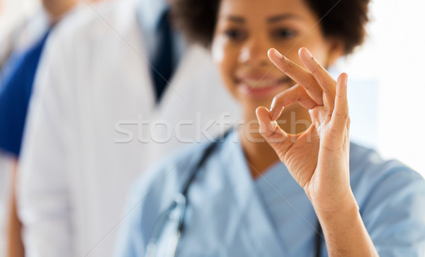 close up of doctor or nurse showing ok sign Stock photo © dolgachov