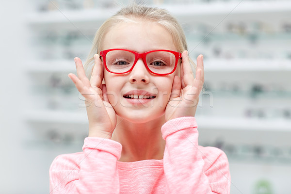 little girl in glasses at optics store Stock photo © dolgachov