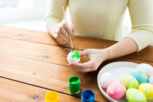 close up of woman hands coloring easter eggs Stock photo © dolgachov