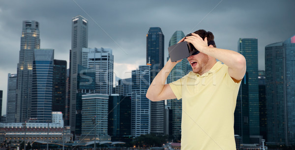 happy man in virtual reality headset or 3d glasses Stock photo © dolgachov
