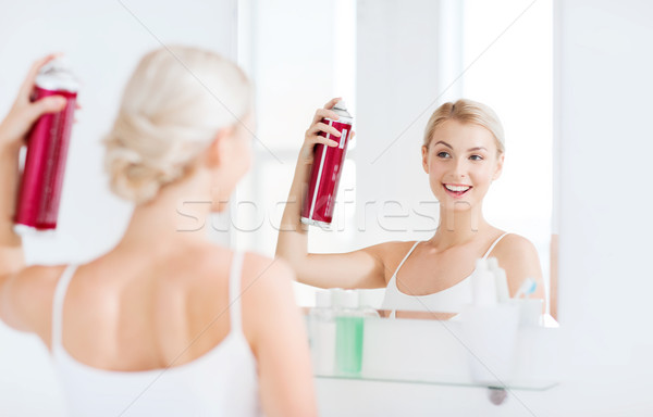 woman with hairspray styling her hair at bathroom Stock photo © dolgachov