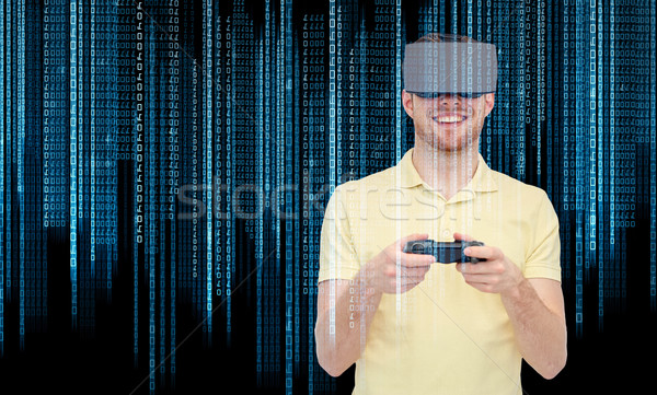 happy man in virtual reality headset with gamepad Stock photo © dolgachov